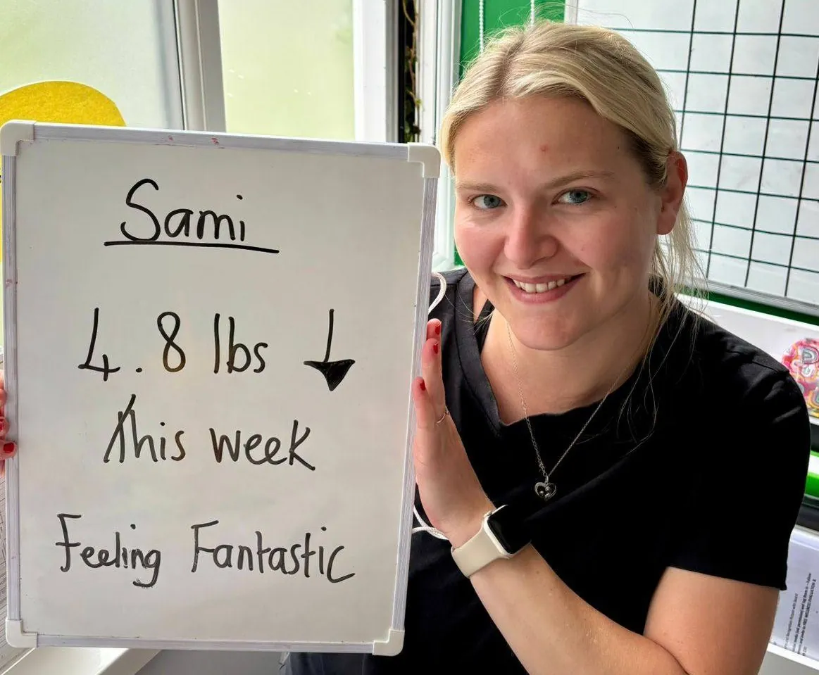 A Willerby Nutrition club member next to their assessment results board